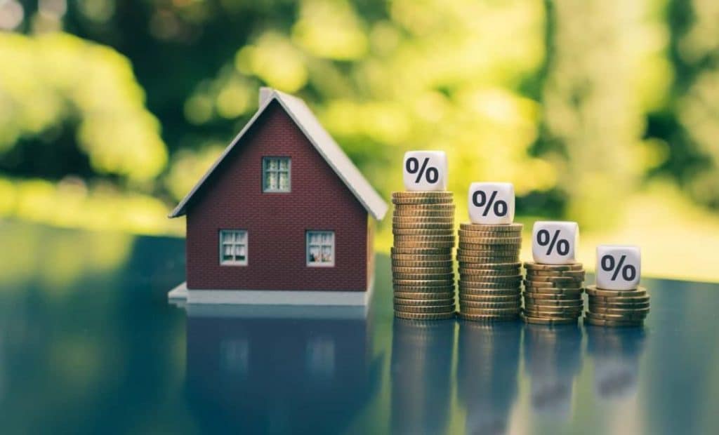 Mortgage rates decline this week house with tiered stack of money representing percentage