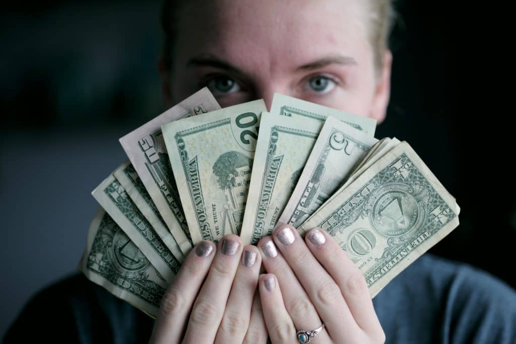 Person Holding Money US Dollars