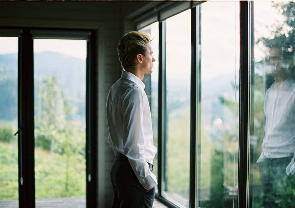 Man Pondering Looking Out Window