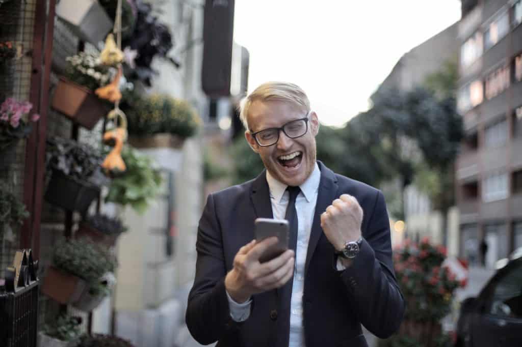 Person Looking at Phone and Cheering