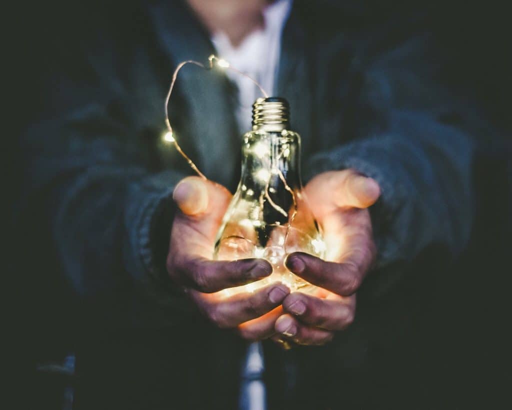 Man Holding a Light Bulb
