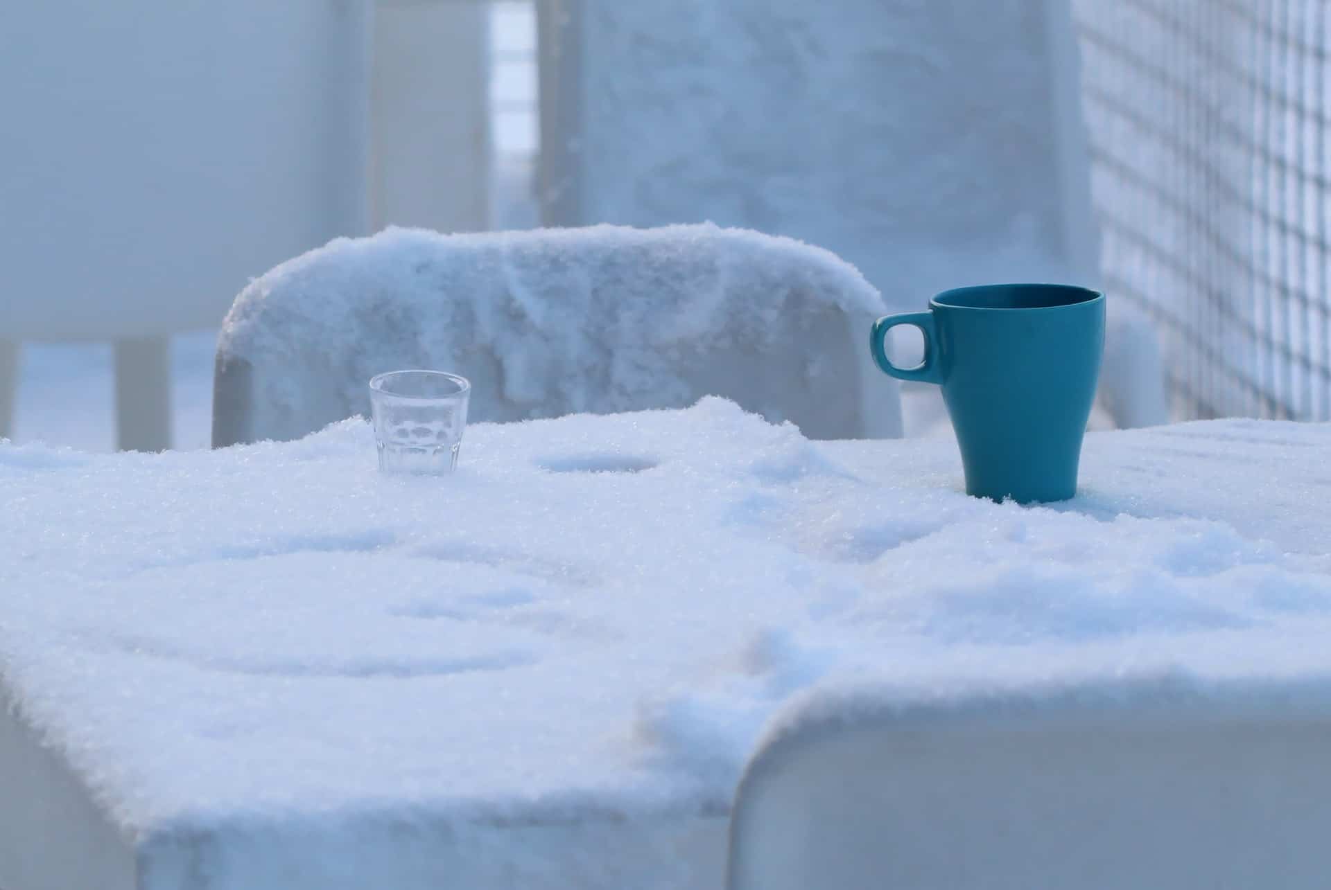 Outdoor Table Covered in Snow Coffe Mug Tea Outdoor Table Covered in Snow Coffe Mug Tea