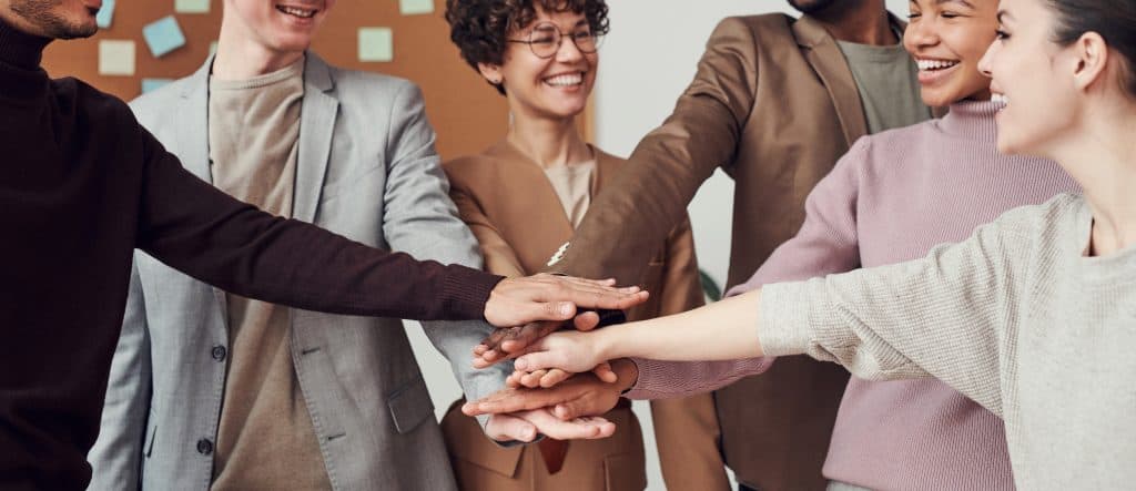team hands in