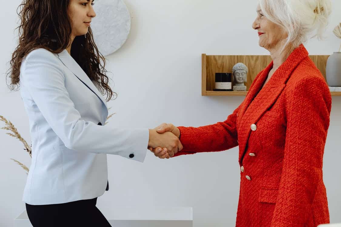 women red leadership handshake
