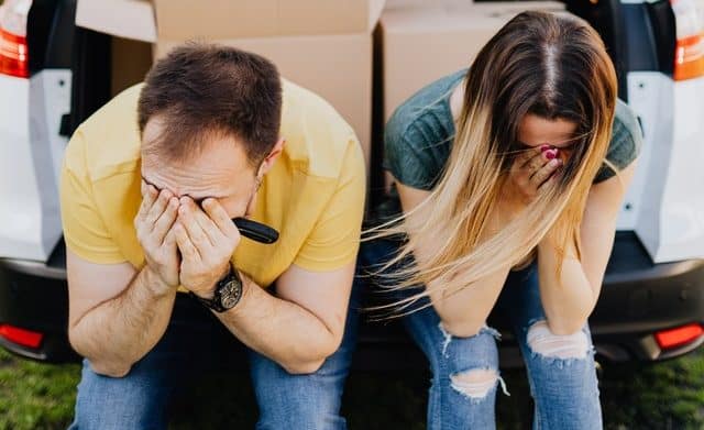 stressed couple moving boxes