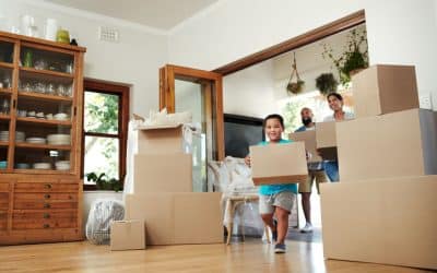 Young family moving boxes into new home as they start over in a new city