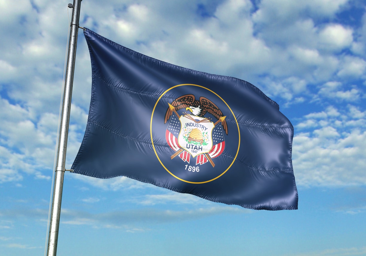 Utah state of United States flag waving cloudy sky background