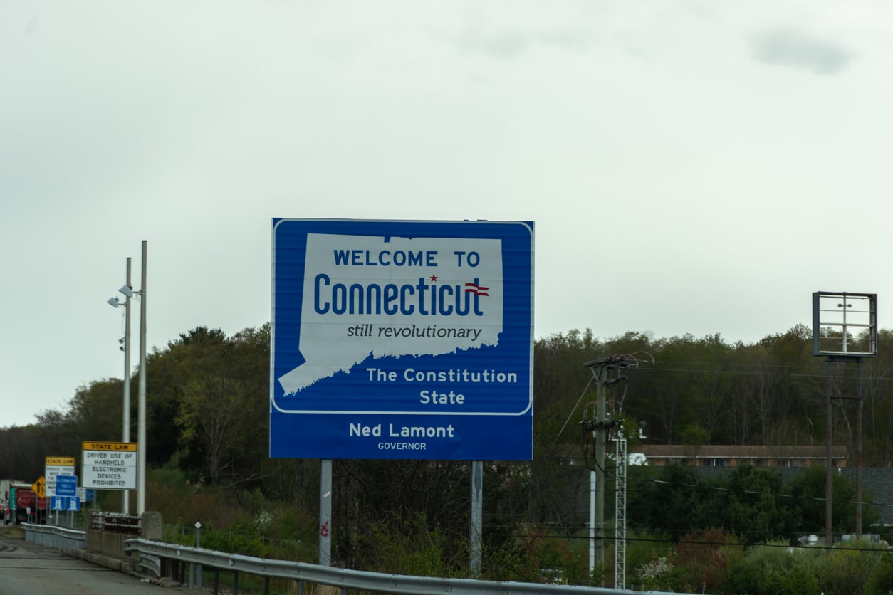 Welcome to Connecticut sign on a gray cloudy day with road construction signs Photo: Rabbitti / iStock