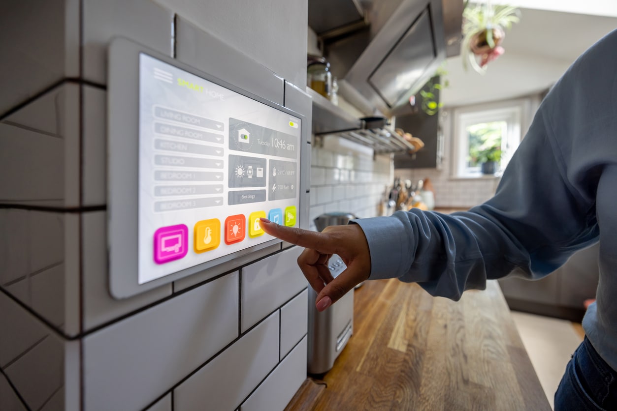 Woman locking the door of her smart home using an automated system