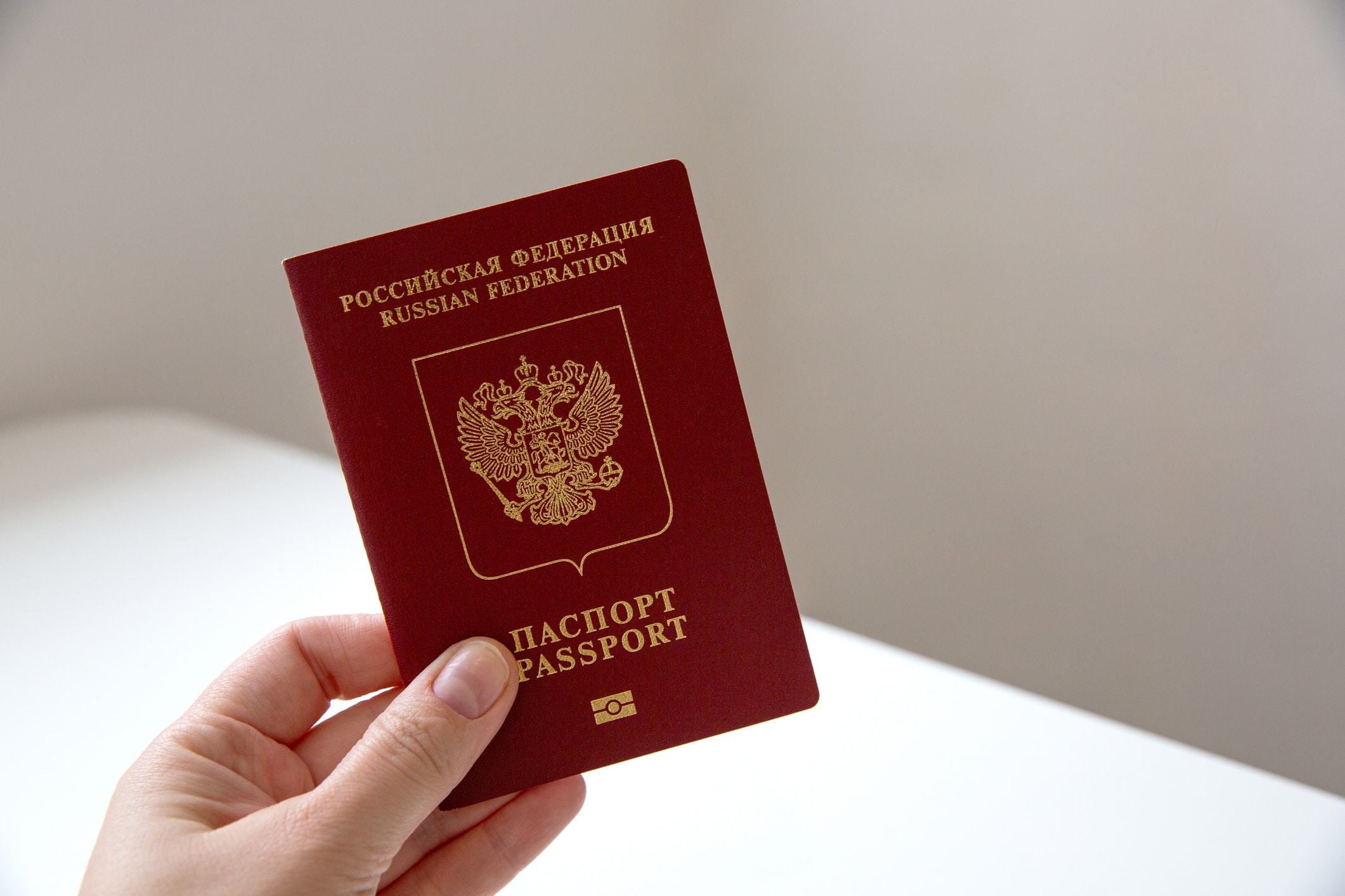 Close up of a female hand holding a Russian passport