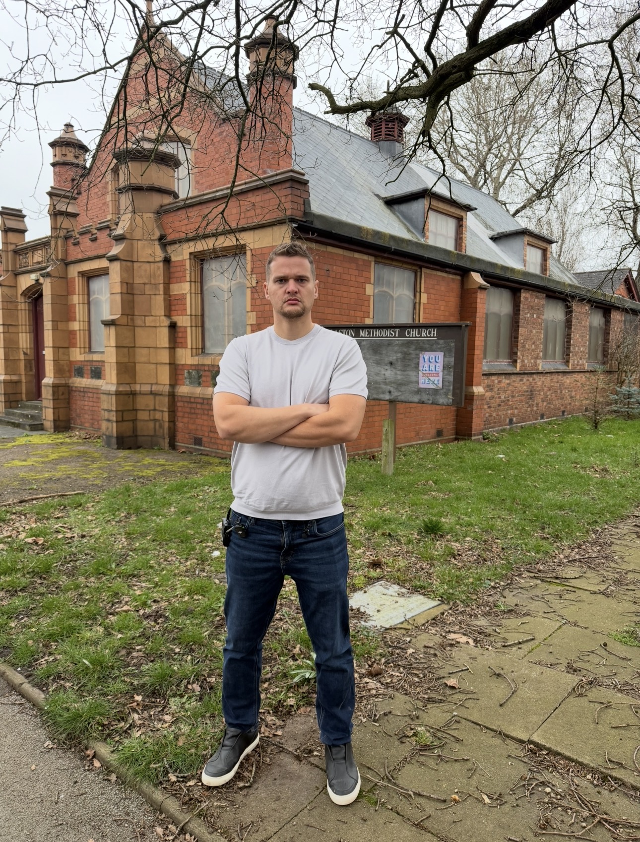 Leeds Man standing in from of house.