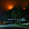 Smoke from the Bobcat Fire rises behind a Southern California residential area