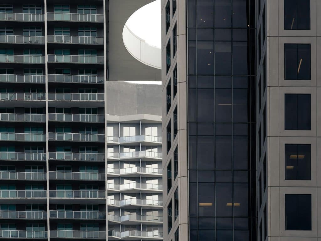Modern high-rise residential buildings with balconies, illustrating condominium projects subject to mortgage project eligibility rules.