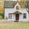 A detached home surrounded by autumn foliage, illustrating the late-September and fall homebuying market.
