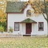 A detached home surrounded by autumn foliage, illustrating the late-September and fall homebuying market.