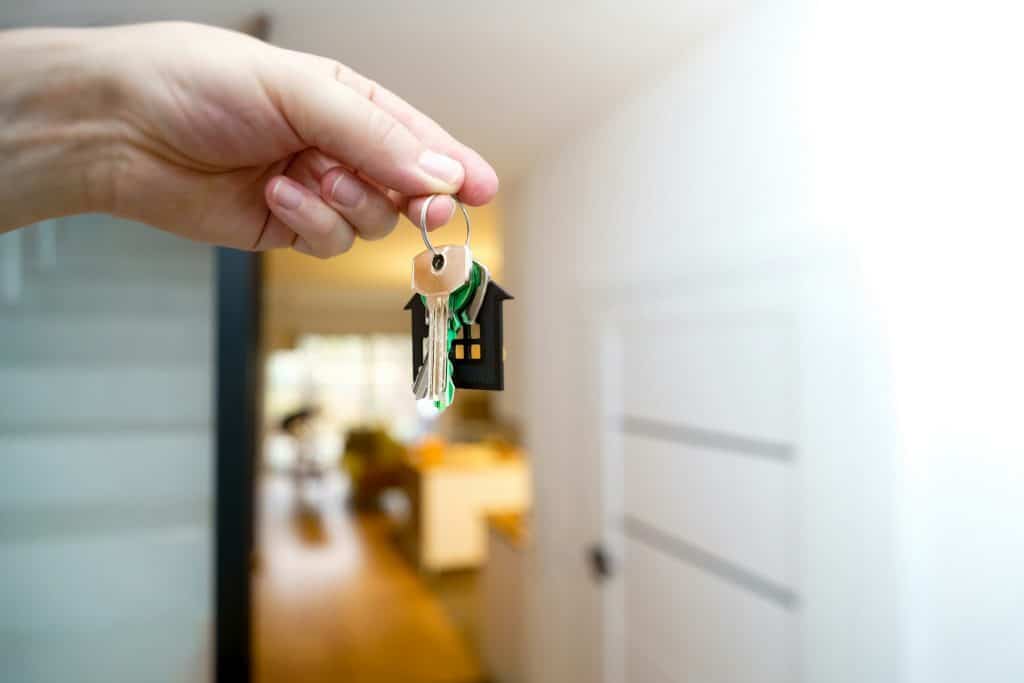 Homebuyer receiving keys, illustrative image for down-payment coverage. Photo by Jakub Żerdzicki/Unsplash.