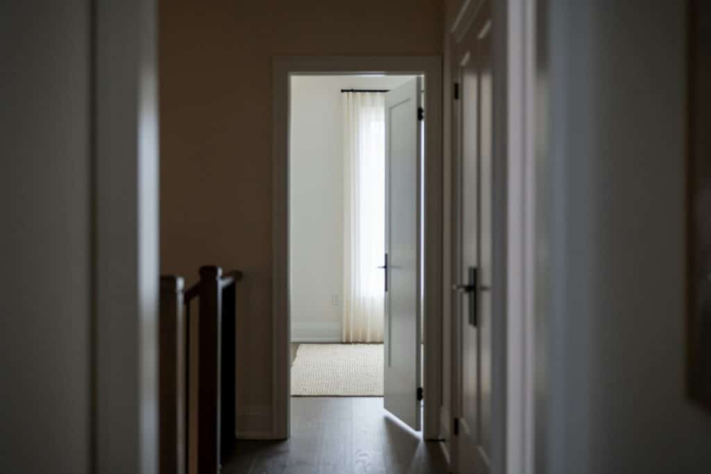 Open doorway into a bright residential interior illustrating homes available to buyers as pending sales slow.