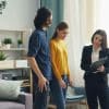 Two people standing inside a residential property during a home visit