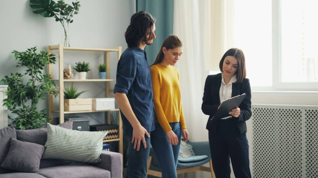 Two people standing inside a residential property during a home visit