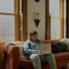 Homeowner using a laptop, illustrating Newrez HomeHub