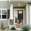 People outside a home, illustrating U.S. housing affordability pressures discussed by Federal Reserve Governor Michael Barr