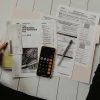 Financial documents and calculator, illustrating mortgage servicing-right valuation and recapture accounting