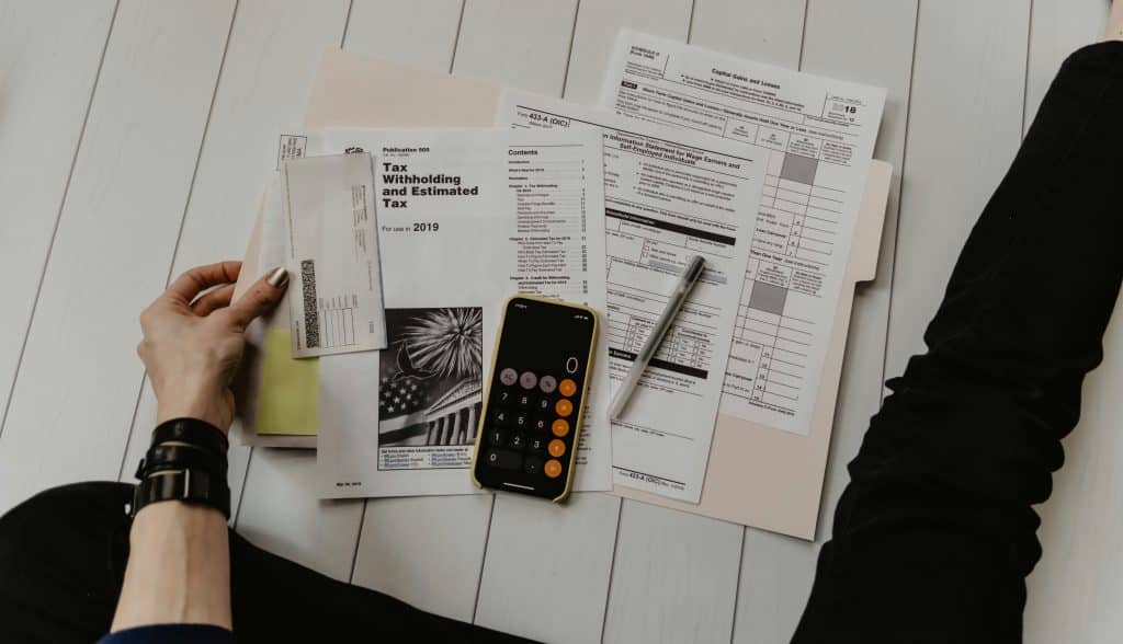 Financial documents and calculator, illustrating mortgage servicing-right valuation and recapture accounting