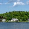 Homes along a forested lakeshore in New Hampshire, used as an illustrative image for residential development financing