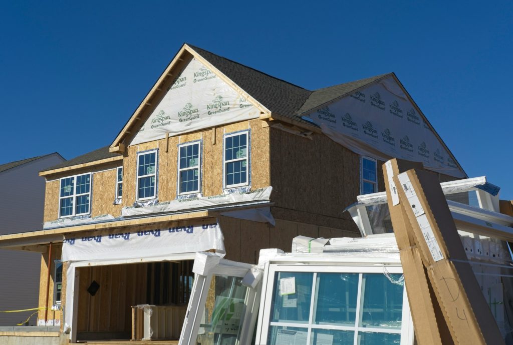 Home under construction, illustrative image for new-home sales coverage. Photo by Ernie Journeys/Unsplash.