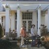 Older adults standing outside a home, illustrating the senior homeowners served by the reverse mortgage market.
