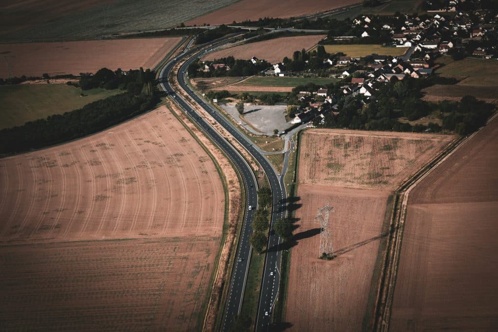 Aerial view of a small rural community surrounded by agricultural fields, illustrating rural rental housing preservation
