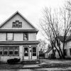 Older detached home in a residential neighborhood, illustrating properties tied to seasoned delinquent mortgage loans.