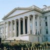 The U.S. Treasury Building in Washington, D.C., with its columned exterior and American flag.
