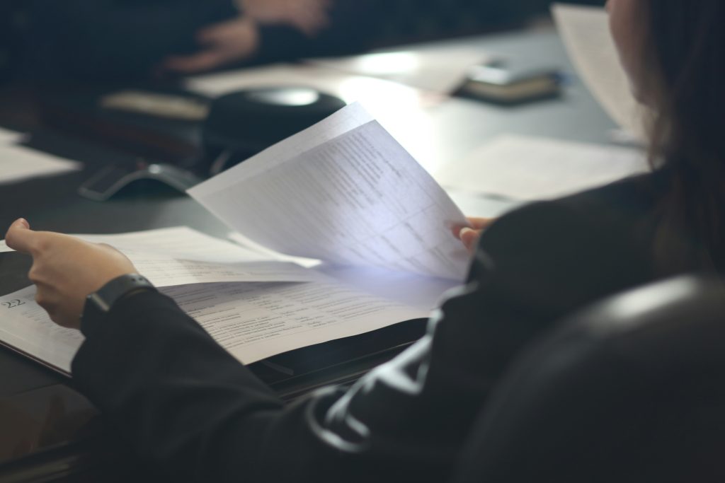 Mortgage professional reviewing documents, illustrating UWM's Underwriting+ program