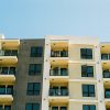 Modern apartment building with balconies against a blue sky, illustrating rental housing