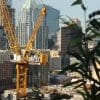 Construction crane above an urban building site, illustrating multifamily development
