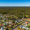 Aerial view of Australian residential housing bordering bushland, illustrating the land-lease housing market