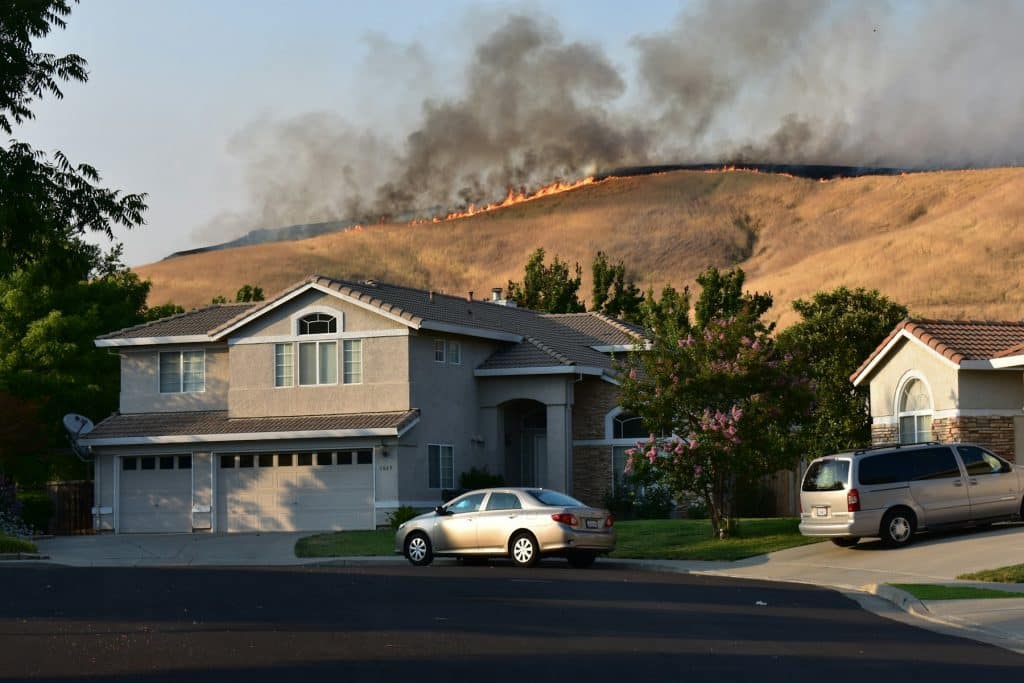 California neighborhood wildfire in 2018, illustrative of wildfire recovery challenges