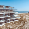 Coastal high-rise illustrating luxury condominium development; not a photograph of the specific subject