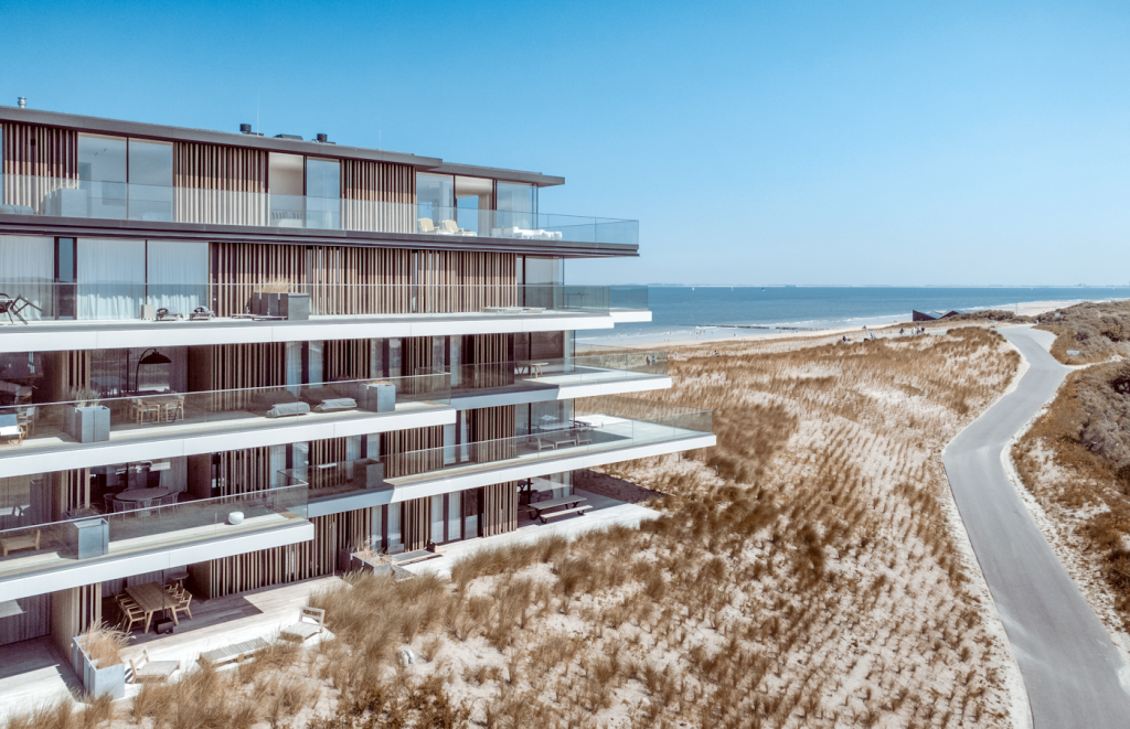 Coastal high-rise illustrating luxury condominium development; not a photograph of the specific subject