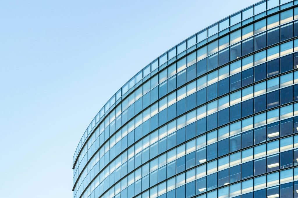 Glass commercial office building, illustrating leasing and capital markets activity