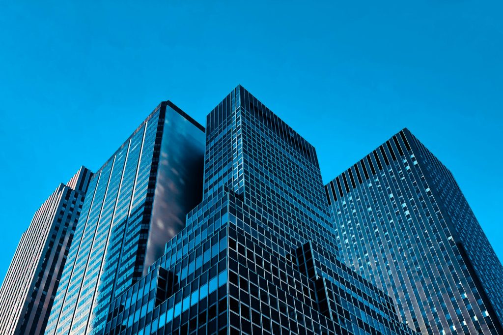 Modern commercial office towers photographed from below; illustrative image, not a CBRE property