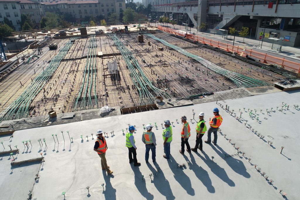 Construction workers at a building site, illustrating employment costs in the housing and construction economy