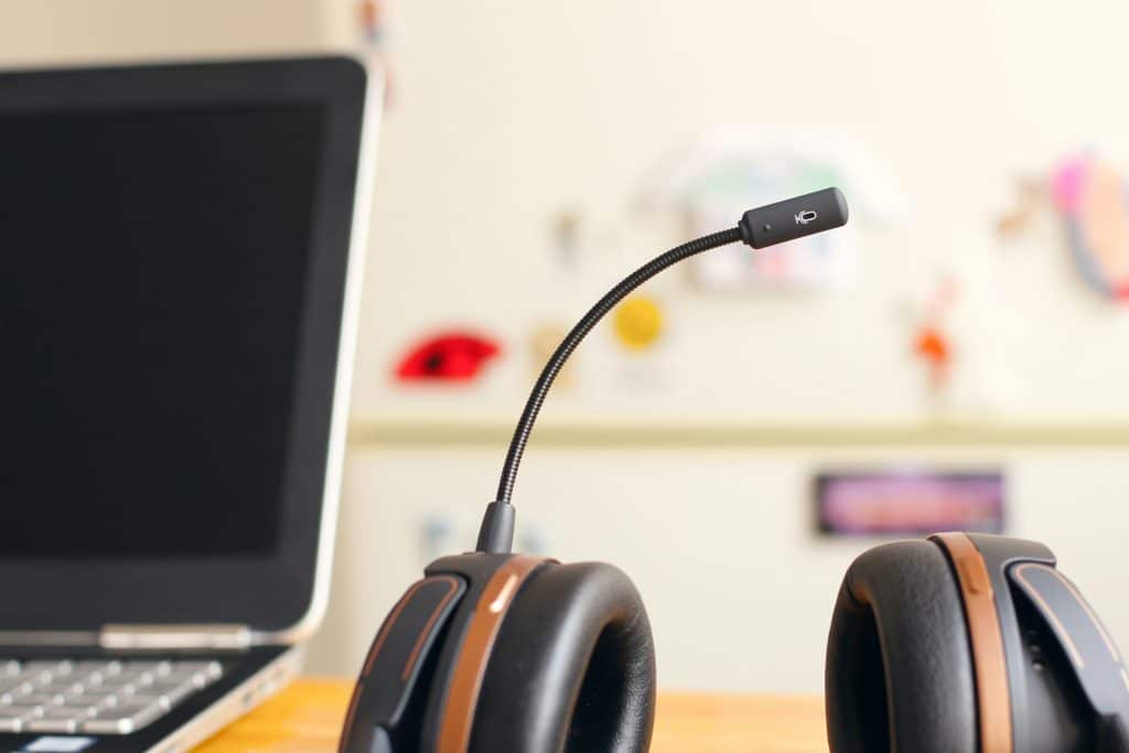 Headset next to a laptop computer, illustrating remote mortgage borrower service