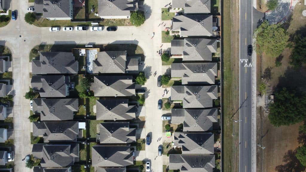 Aerial view of residential neighborhood illustrating homebuilder consolidation; representative photo