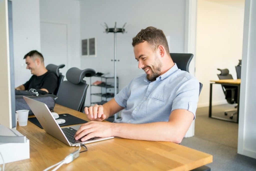 Professional using laptop in a bright office