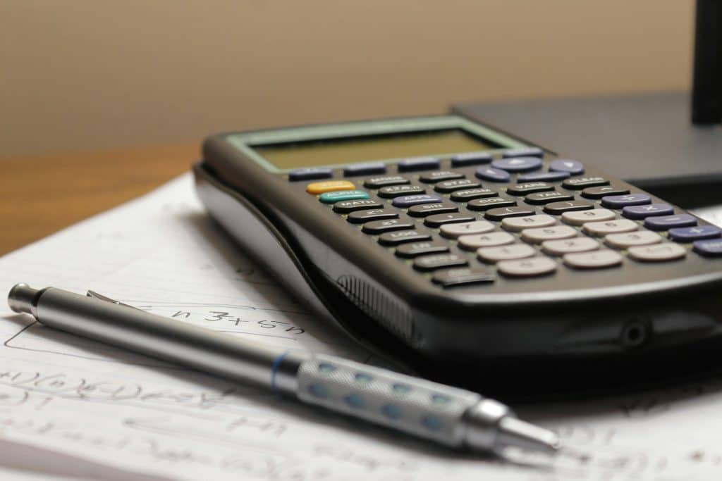 Calculator and financial documents illustrating mortgage credit reporting and verification