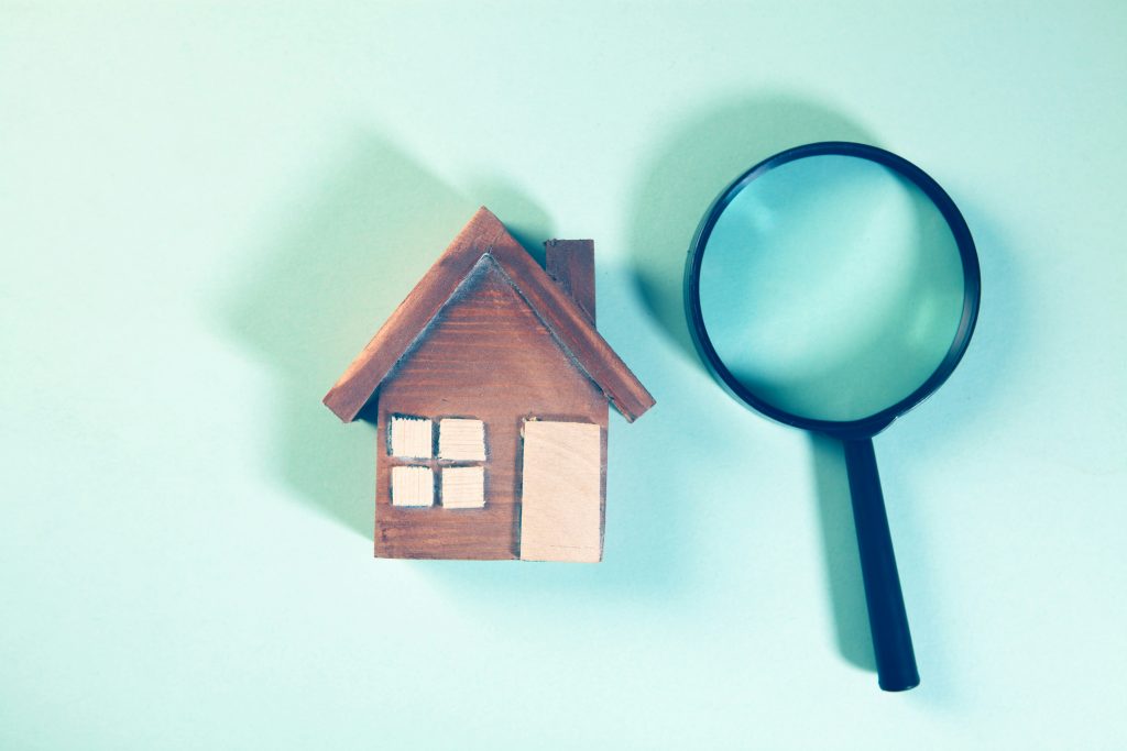House model and magnifying glass illustrating FHA appraisal modernization and UAD 3.6
