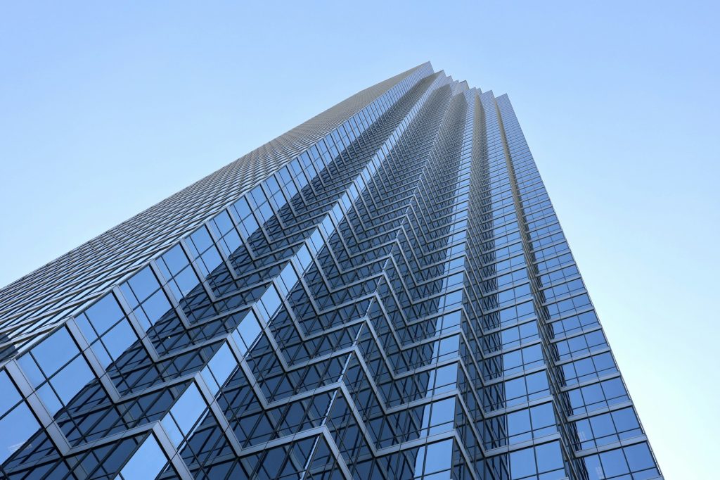 Modern glass commercial tower representing the banking sector; illustrative, not a First Financial or Finward building