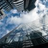 Glass office buildings seen from below, illustrating mortgage-backed securities and capital markets